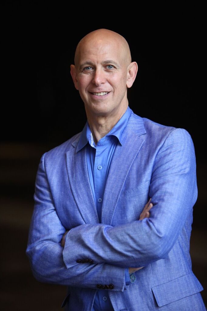 Headshot of Dr. Doug Lehrer - man wearing blue suit smiling