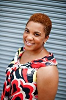 Headshot of Andrea Hancock - woman with red black top smiling