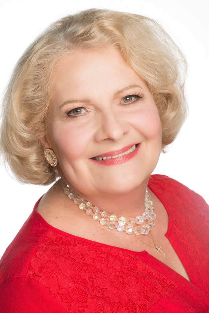 Headshot of Carol Stanley wearing a red top