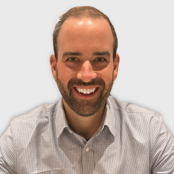 Headshot of Chris Sheppard - wearing grey dress shirt