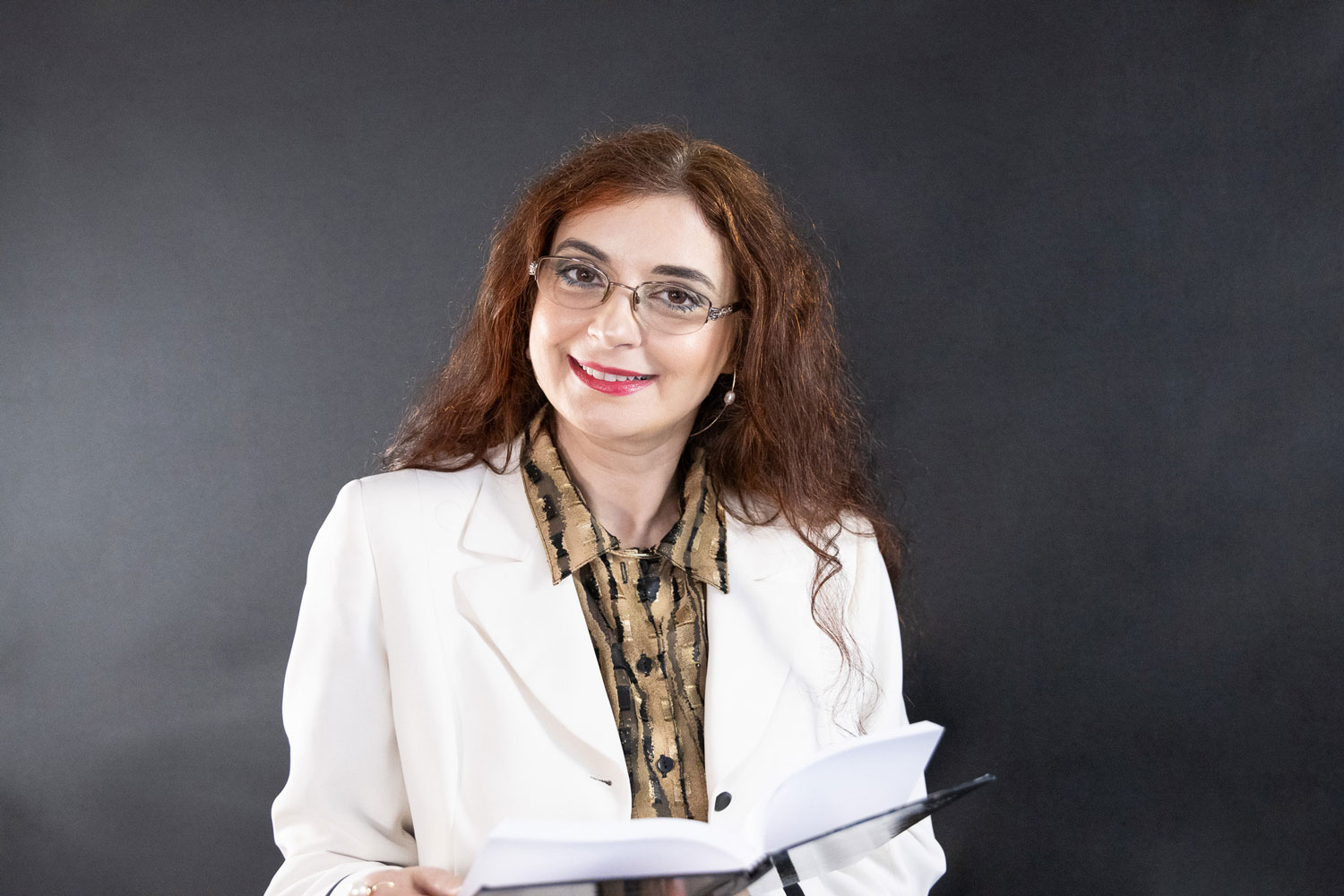 Headshot of Lisa E. Kirkwood holding a book