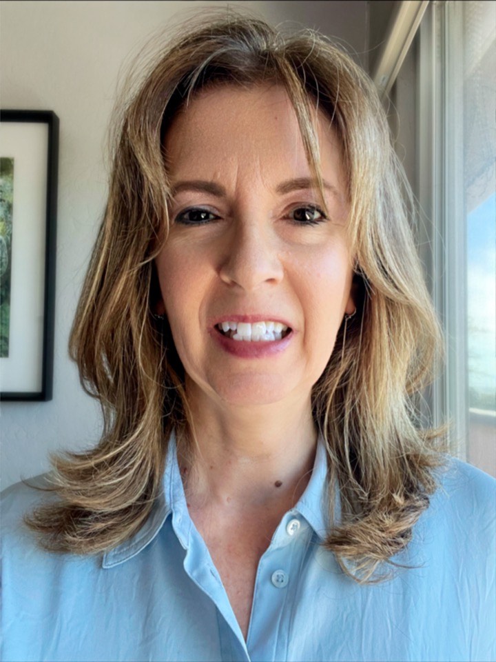 Headshot of Lisa Towles smiling with long light brown hair