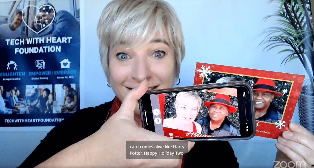 Photo of Michelle Calloway - holding cell phone with image from holiday card