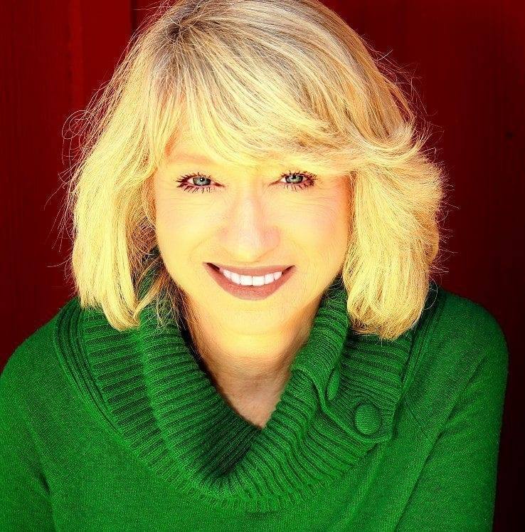 Headshot of Mary Maas wearing a green sweater
