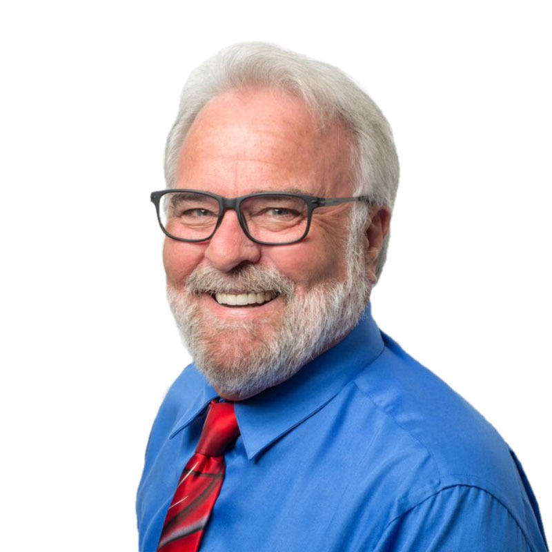 Headshot of business coach and digital marketing strategist Patrick Smith wearing a blue shirt and red tie