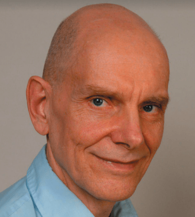 Headshot of Peter Voss, a bald white male with a blue collared shirt