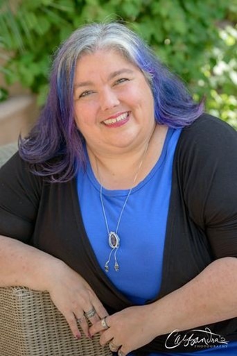 Headshot of Stacy Braiuca - woman with white and purple hair smiling