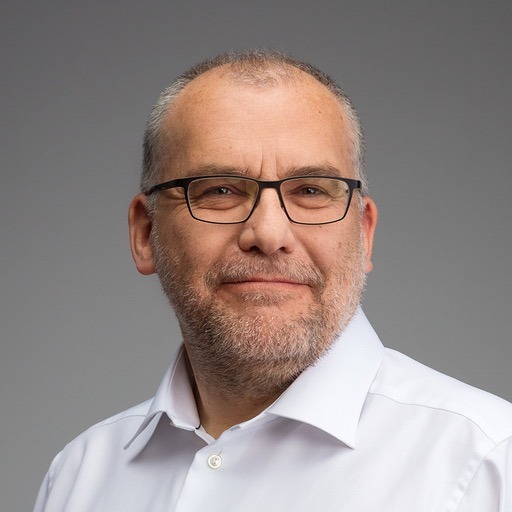 Vaclav_square Headshot of Vaclav Vincalek in a white buttoned shirt wearing glasses.
